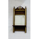 Simulated rosewood and parcel gilt wall mirror, with architectural top and urn finials, with a