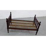 A stained wood rack with four urn finials 40 x 71cm