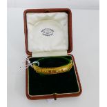 An Edwardian 9 carat gold bangle set with diamond and rubies, full set of hallmarks for Chester 1906