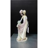 A Lladro Spanish porcelain figure of a girl in 1920's costume with feathers in her hair, 34cm high