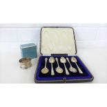 A set of six Sheffield silver teaspoons in a fitted case together with a Birmingham silver napkin