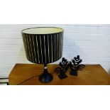 A contemporary table lamp and shade, together with a pair of black metal cockerel candlestick