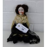 A Victorian porcelain head doll, with blue eyes and brown hair, straw filled body and composition