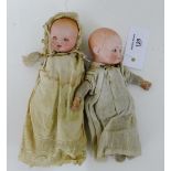 An Armand Marseille bisque head baby doll, with open and close sleeping eyes, dressed in linen smock