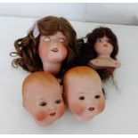 A collection of dolls heads to include two Armand Marseille 351 baby heads, 390 girls head and a