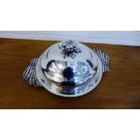 A stylish Italian silver plated meat dish and cover, the domed top with a flowerhead handle, 54cm