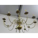 A large Dutch style 12 branch brass light fitting, approx 130cm wide