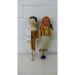 A vintage painted wooden head and body doll, 28cm long together with a vintage costume doll 29cm