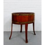 A mahogany and brass bound oval jardiniere stand on splayed supports, 76 x 80cm