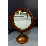 A mahogany framed dressing mirror, the circular plate on a turned column and scrolled support, 58