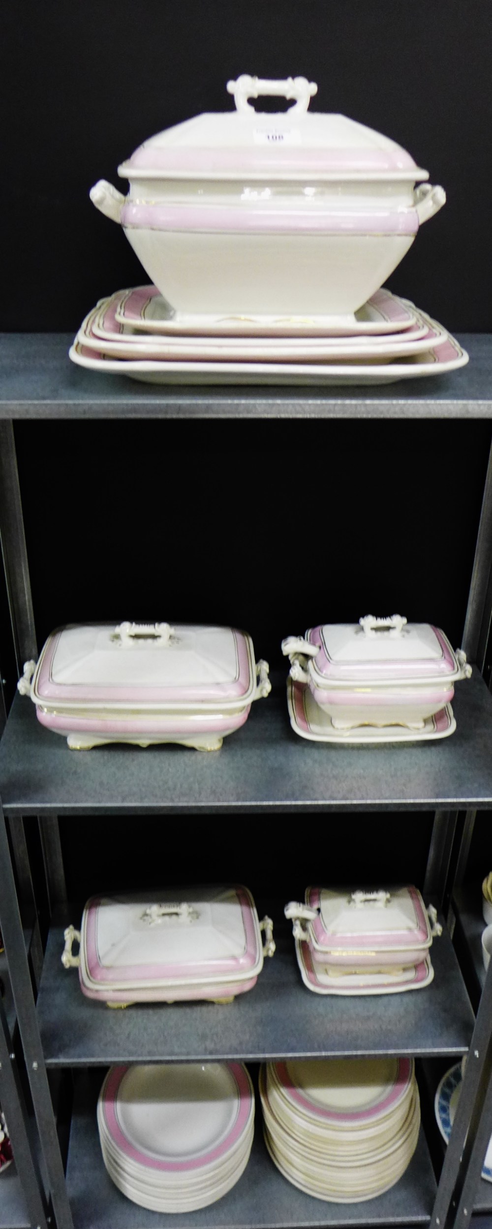 An Ironstone china extensive dinner service with pale pink borders and gilt rims comprising dinner