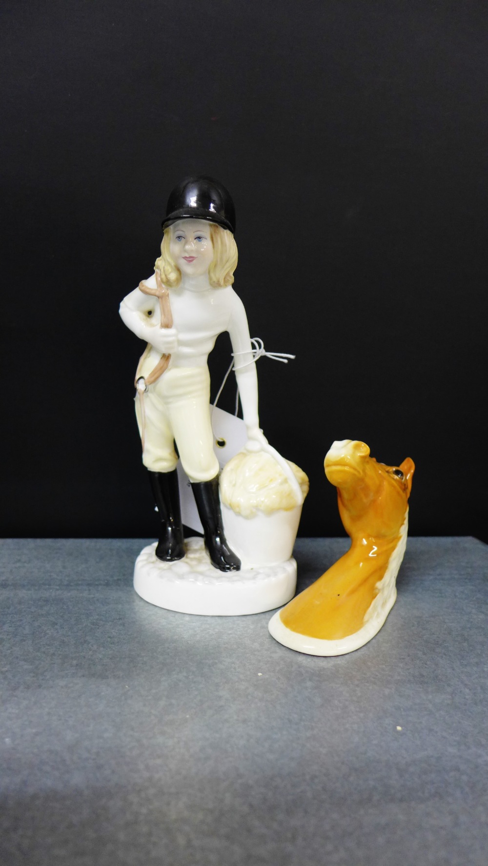 A Beswick Palomino horse wall plaque, together with a Coalport 'Feeding Time' porcelain figure,