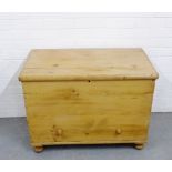 A stripped pine storage chest, the rectangular top opening to reveal a void interior with candle box