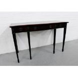 A mahogany side table, the serpentine top over three frieze drawers on tapering square supports