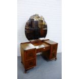 An Art Deco burr walnut dressing table, the mirrored back over central drawer flanked by two deep