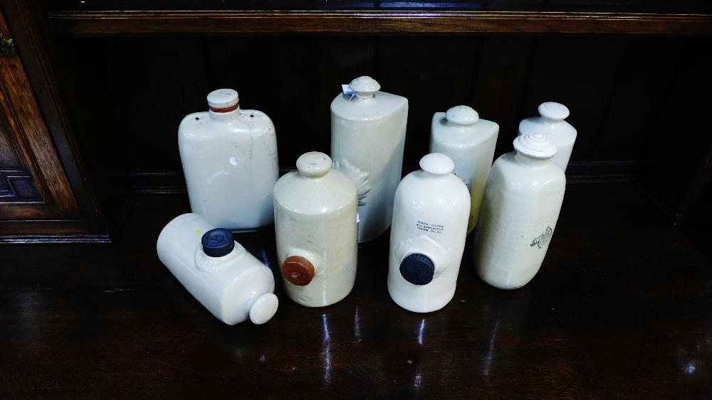 A selection of stoneware foot warmers and flasks to include 'The Doulton Reliable Foot Warmer' by