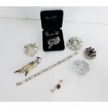 A mixed lot of silver and costume jewellery to include a Modernist brooch, claw brooch. marcasite
