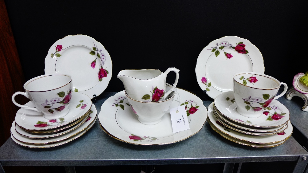 A Cmielow Polish porcelain teaset with rose pattern and gilt rims comprising six cups, six