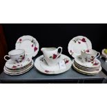 A Cmielow Polish porcelain teaset with rose pattern and gilt rims comprising six cups, six