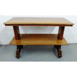 A mahogany two tier table, on carved scroll end supports 78 x 114cm
