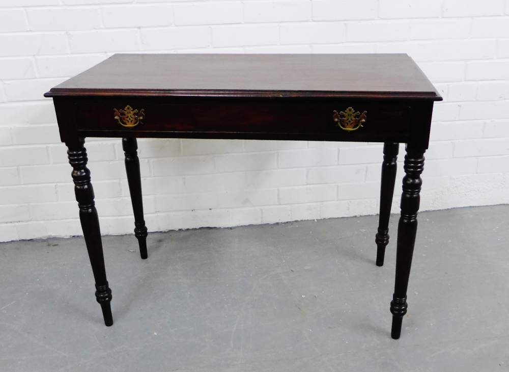 A mahogany side table, the rectangular top over two drawers, raised on turned tapering supports,