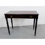 A mahogany side table, the rectangular top over two drawers, raised on turned tapering supports,