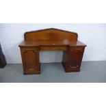 A 19th century mahogany ledgeback sideboard, the break front top with a central single drawer
