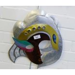A painted metal wall mask