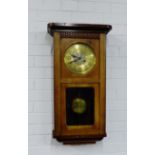 An oak wall clock with brass dial 75 x 40cm