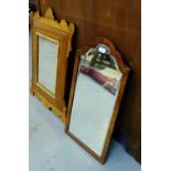 A burr wood framed rectangular wall mirror with domed top, 36 x 71cm, together with another mahogany