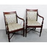 A pair of mahogany open armchairs with upholstered backs and seats on turned supports and stretchers