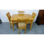A contemporary beech wood dining table and set of four spar back chairs (5) 76 x 120cm