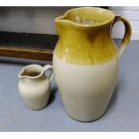 A large stoneware two tone jug, 45cm high, together with a three pint stoneware jug, (2)