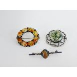 Two silver and Scottish coloured hardstone brooches together with another in white metal (3)