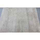 A contemporary natural coloured pile rug 160 x 230cm