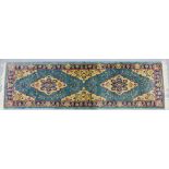 A blue runner with foliate pattern and border, 250 x 70cm