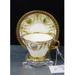 A Cauldon England porcelain cabinet cup and saucer with gilt reticulated border and scrolling vine