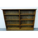 An oak library bookcase with rectangular top and planked back with an arrangement of adjustable