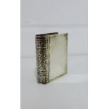 A white metal snuff box in the form of a book, 4 x 3 cm