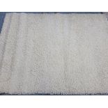 A contemporary cream coloured pile rug 160 x 230cm