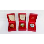 A collection of three Halcyon Days enamel Christmas boxes to include 2002, 2003 and 1999, all in red