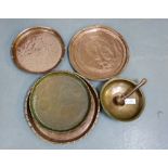A collection of Middle Eastern copper items to include circular pie crust edge trays, a bowl and a