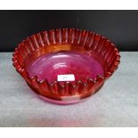 A cranberry glass bowl with frilled rim, 22cm wide