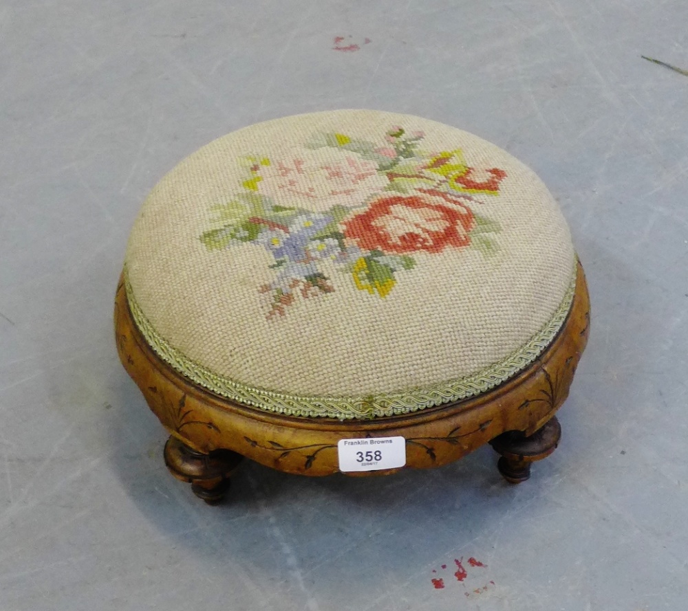 A walnut circular foot stool with tapestry top