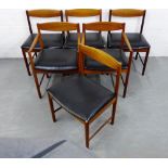 A set of six McIntosh teak dining chairs, including two carvers, with black vinyl seats and turned