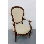 A walnut framed open armchair with cream upholstered back, arms and seat, on cabriole supports,