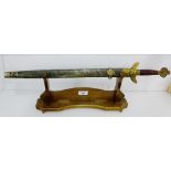 A Chinese short sword with brass hilt and wooden handle, complete with shagreen sheaf, mounted on