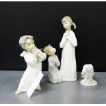 Three Lladro porcelain figures to include a Cherub, a boy and girl modelled kneeling and praying
