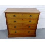 A walnut chest, the rectangular top with moulded edge and canted corners, over four long drawers, on
