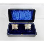 A pair of George V silver circular salts, in fitted leather case, Birmingham 1919
